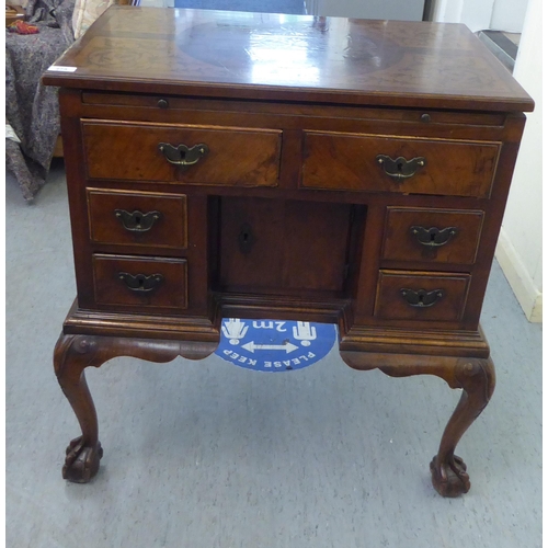 273 - An early 19thC carved satinwood and walnut inlaid desk, the top with marquetry decoration over a cen... 