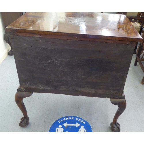 273 - An early 19thC carved satinwood and walnut inlaid desk, the top with marquetry decoration over a cen... 