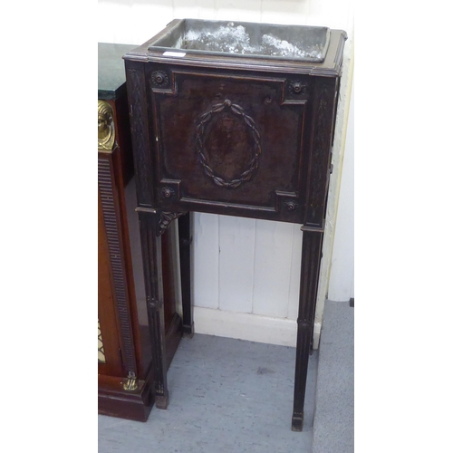 275 - An Edwardian mahogany jardiniere stand with a tinplate liner, the front panel decorated with a garla... 