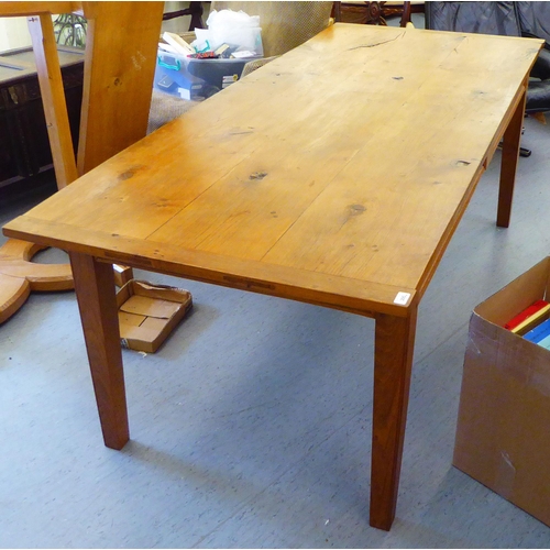 295 - A modern oak refectory table, the one piece top raised on square, tapered legs  30