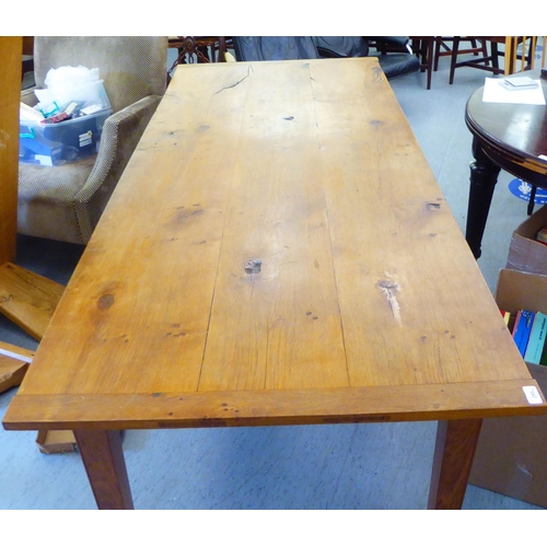 295 - A modern oak refectory table, the one piece top raised on square, tapered legs  30