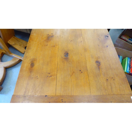 295 - A modern oak refectory table, the one piece top raised on square, tapered legs  30