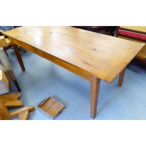 295 - A modern oak refectory table, the one piece top raised on square, tapered legs  30