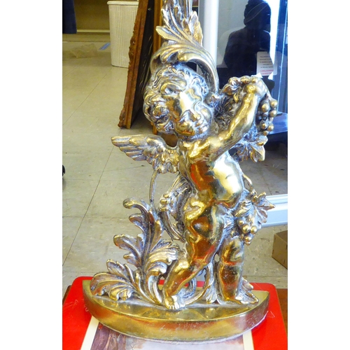 43 - A 20thC cast brass door porter, fashioned as a cherub holding grapes with additional foliage ornamen... 