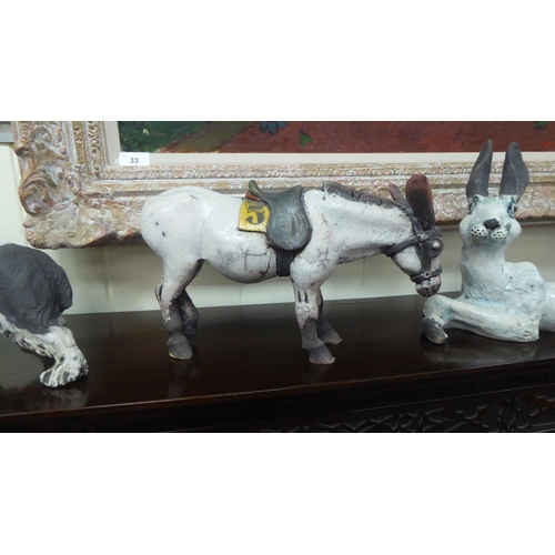 53 - Five 20thC crackle glazed and overpainted model animals, viz. a cow, a hare, a rabbit, a spaniel and... 