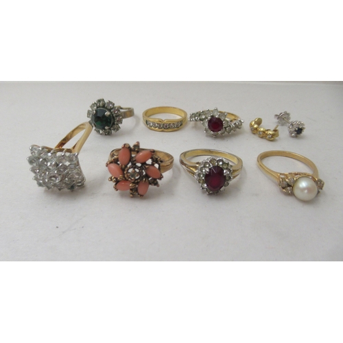 73 - Seven dress rings, set with coloured stones; a yellow metal earring; and a white metal earring, claw... 