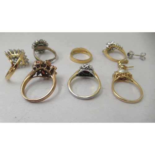 73 - Seven dress rings, set with coloured stones; a yellow metal earring; and a white metal earring, claw... 