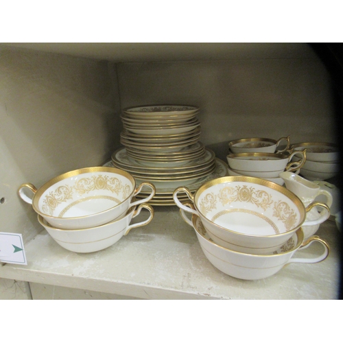 103 - Aynsley bone china tableware, variously decorated in midnight blue and gilding: to include soup bowl... 