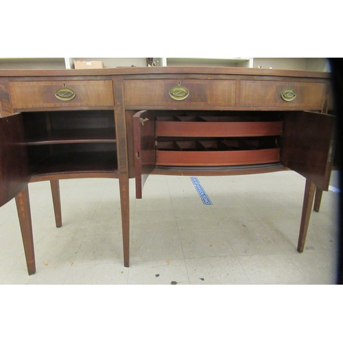 108 - An early 20thC Regency style fan marquetry and string inlaid mahogany serpentine front sideboard, co... 