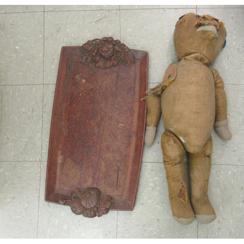 146 - A mixed lot: to include an early 20thC Teddy bear; a carved softwood tray  23