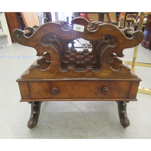 266 - A late Victorian walnut Canterbury with a divided upper section, over a base drawer, raised on splay... 