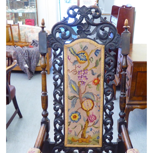 278 - A late Victorian oak framed hall chair, having an ornately pierced, carved back with a tapestry upho... 