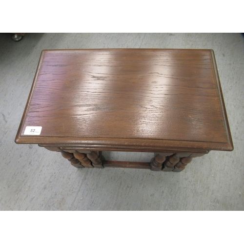 52 - A nesting set of three 20thC Old English style, stained oak occasional tables  largest 17