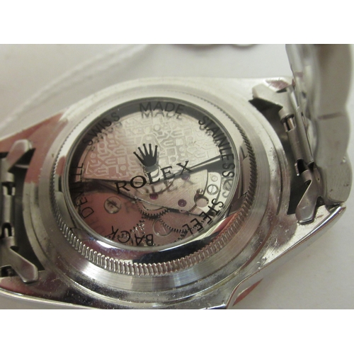 65 - A stainless steel cased bracelet wristwatch, faced by a baton dial with date aperture