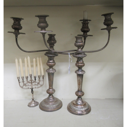 87 - Silver plate: to include a pair of 20thC Georgian style twin branch table candelabra, each with a ce... 