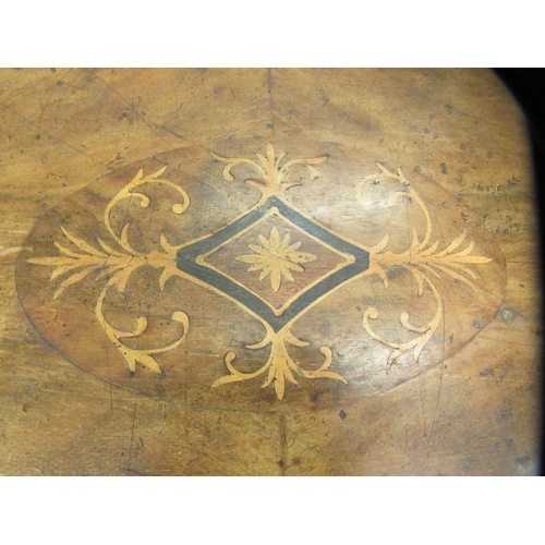 140 - A late Victorian walnut breakfast table, the oval, quarter veneered tip top with marquetry ornament,... 