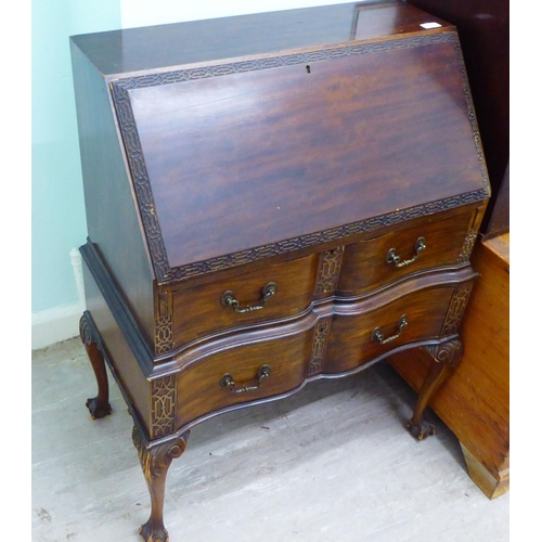 19 - A 1920s/30s mahogany bureau with a fall front, over two serpentine front drawers, raised on cabriole... 