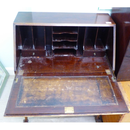 19 - A 1920s/30s mahogany bureau with a fall front, over two serpentine front drawers, raised on cabriole... 