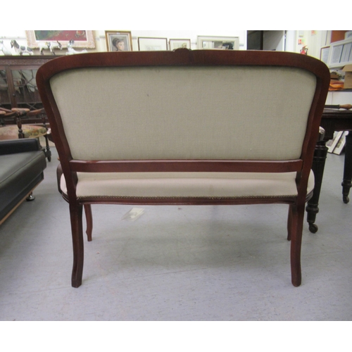 235 - A modern reproduction of a French inspired, stained beech framed, two person, cottage settee, uphols... 