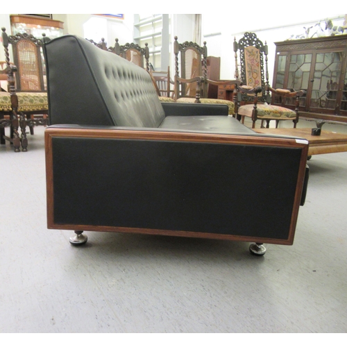 238 - A G-Plan day bed/settee, upholstered in black vinyl with a teak showwood frame, raised on pegged fee... 