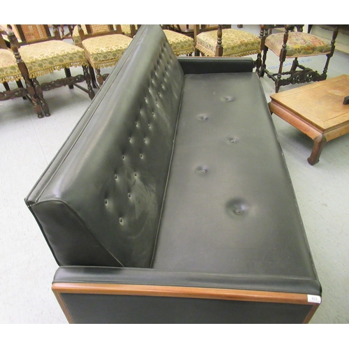 238 - A G-Plan day bed/settee, upholstered in black vinyl with a teak showwood frame, raised on pegged fee... 