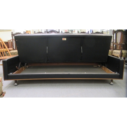 238 - A G-Plan day bed/settee, upholstered in black vinyl with a teak showwood frame, raised on pegged fee... 