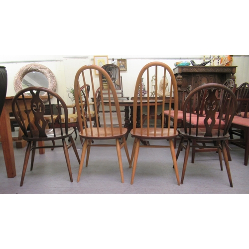 265 - Four similar Ercol stained beech framed spindle back chairs, raised on turned legs