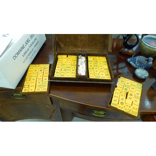 5 - A 1920s/30s Mah Jong set with resin tiles and bone sticks, in a brown hide case