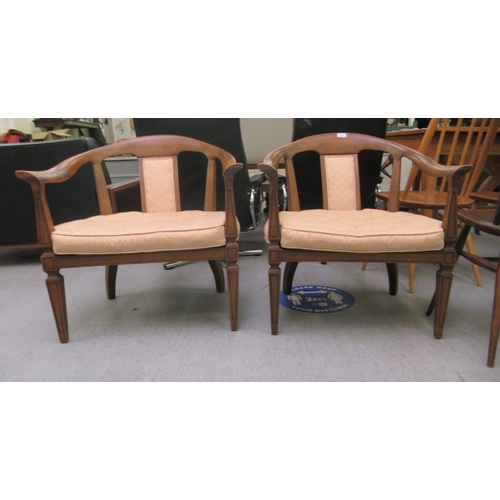 75 - A pair of 20thC antique finished walnut framed horseshoe shaped chairs with upholstered splats and b... 