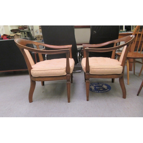 75 - A pair of 20thC antique finished walnut framed horseshoe shaped chairs with upholstered splats and b... 