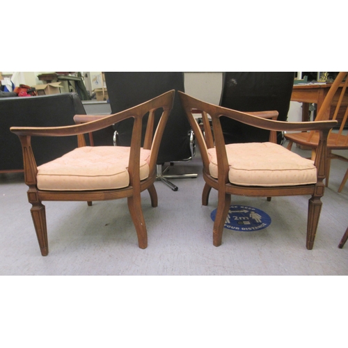 75 - A pair of 20thC antique finished walnut framed horseshoe shaped chairs with upholstered splats and b... 