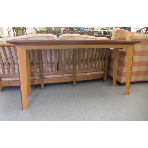 36 - A modern light oak hall table, raised on tapered legs  28