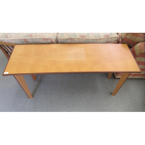 36 - A modern light oak hall table, raised on tapered legs  28