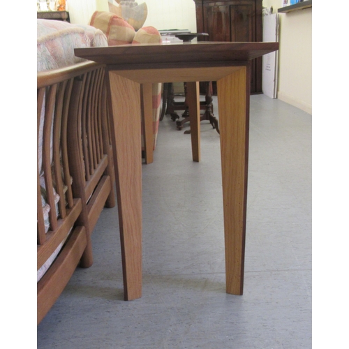 36 - A modern light oak hall table, raised on tapered legs  28