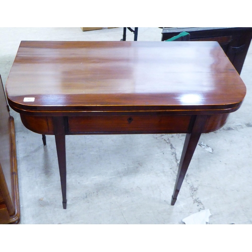 57 - A Regency mahogany card table with a foldover top, raised on square, tapered legs  29