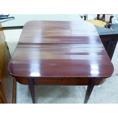 57 - A Regency mahogany card table with a foldover top, raised on square, tapered legs  29