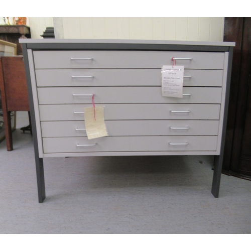 63 - A modern grey painted laminate six drawer plan desk, raised on rectangular legs  33