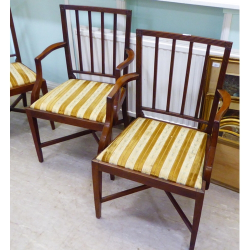 64 - A set of eight early 20thC Georgian design mahogany framed dining chairs, each with a slatted back a... 