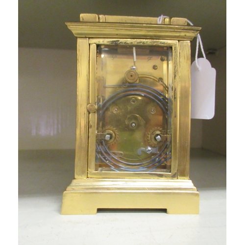 67 - A lacquered brass and glazed cased carriage timepiece; the movement faced by a Roman dial, branded f... 