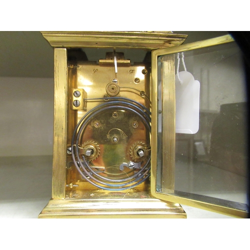 67 - A lacquered brass and glazed cased carriage timepiece; the movement faced by a Roman dial, branded f... 