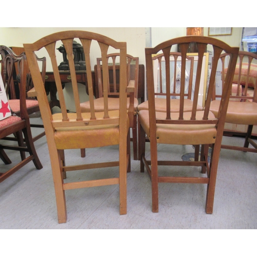 79 - A set of eight mid 20thC satin mahogany framed and carved dining chairs with stud upholstered seats,... 