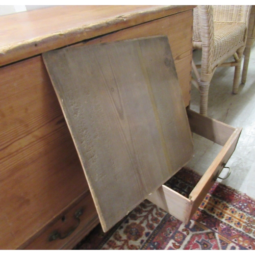 18 - A late Victorian pine blanket chest with a hinged lid, raised on bracket feet  24