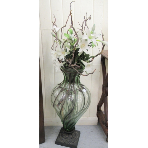 35 - A modern metal bound glass floorstanding vase with a faux flower display  40