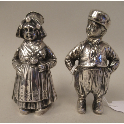 1 - A pair of Continental silver novelty pepper pots, respectively fashioned as a standing Dutch boy and... 