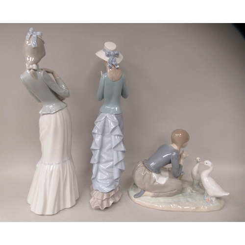 100 - Four Lladro porcelain figures; and another by Royal Copenhagen, a little girl holding a doll  4