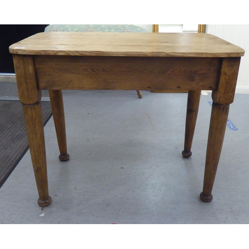 111 - A late 19th/early 20thC rustically constructed pine kitchen table, the planked top with round corner... 