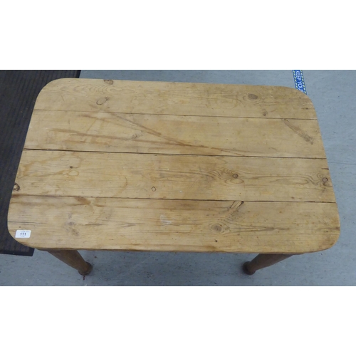 111 - A late 19th/early 20thC rustically constructed pine kitchen table, the planked top with round corner... 