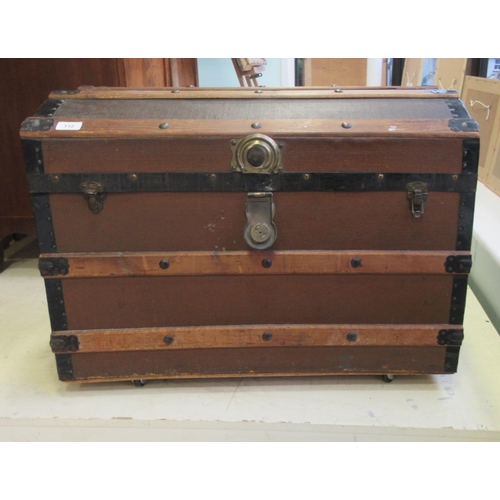 112 - An early/mid 20thC pine bound canvas trunk with straight sides and a hinged lid, on a plinth and cas... 