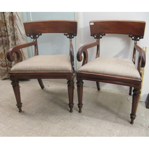 122 - A pair of William IV mahogany framed bar back open arm chairs, the later fabric upholstered drop-in ... 