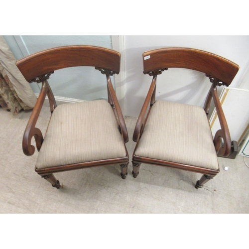 122 - A pair of William IV mahogany framed bar back open arm chairs, the later fabric upholstered drop-in ... 